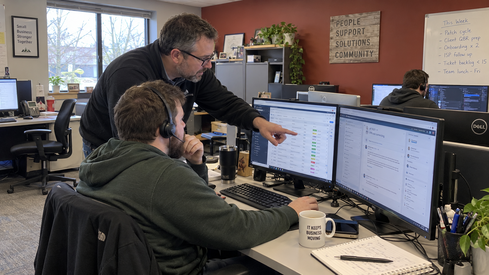 MSP service lead and technician review waiting tickets and first contact resolution at their workstations