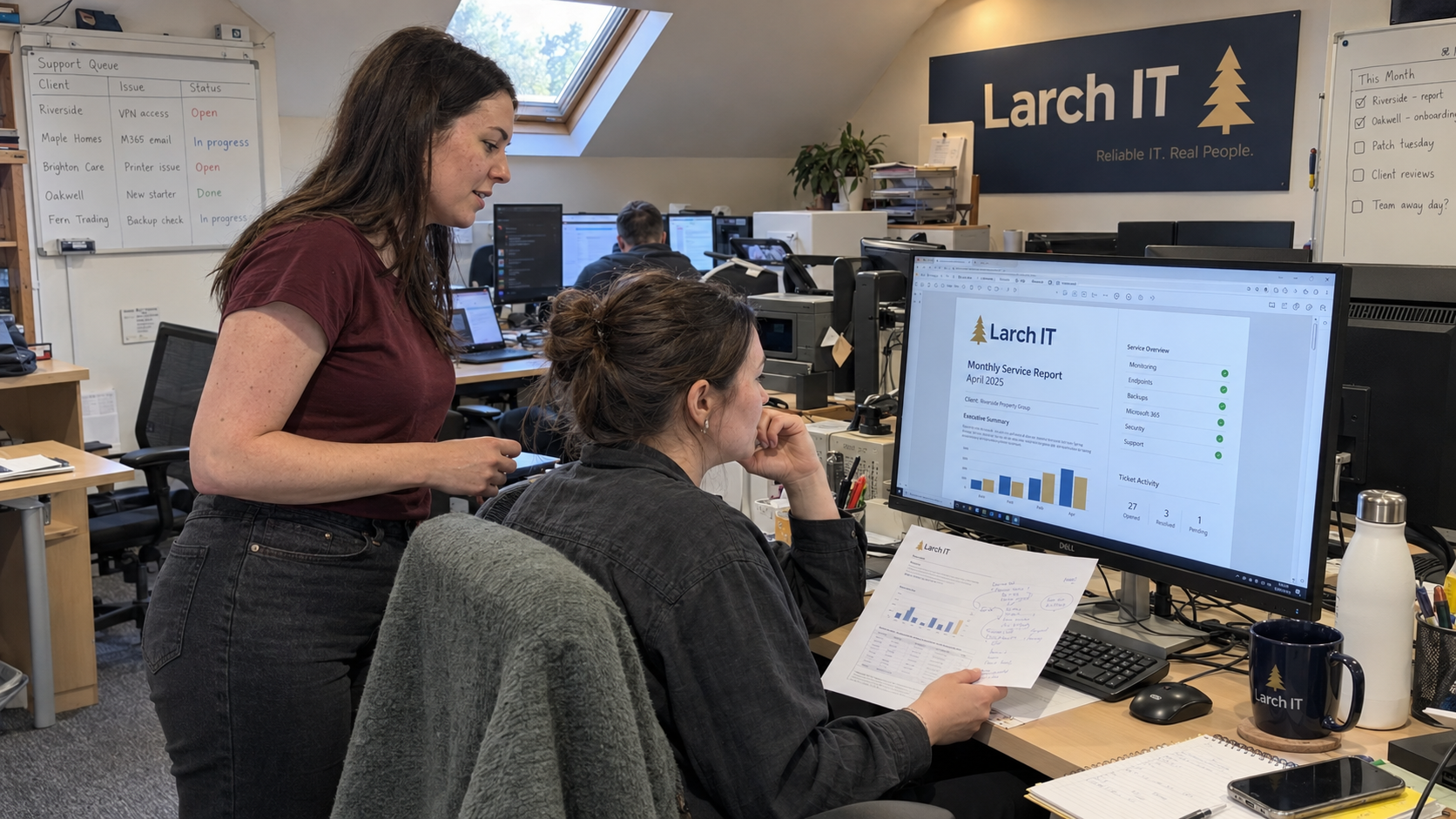 Account manager and technical lead verify a monthly IT report template at an MSP support workstation