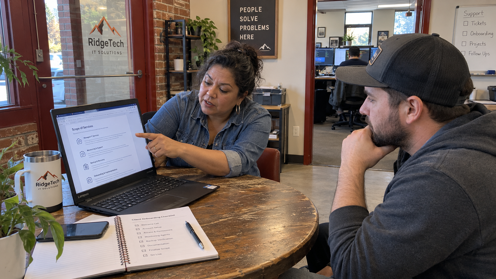 MSP sales lead discusses negotiation concessions and onboarding scope with a prospect at a meeting table