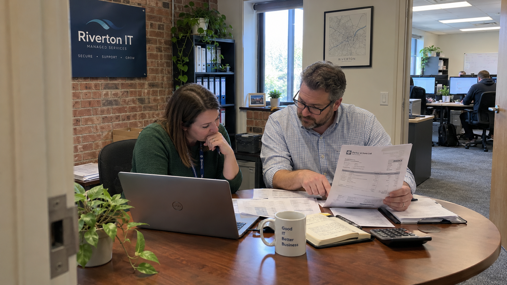 An owner and finance colleague compare an invoice and spreadsheet while investigating MSP EBITDA in their office.