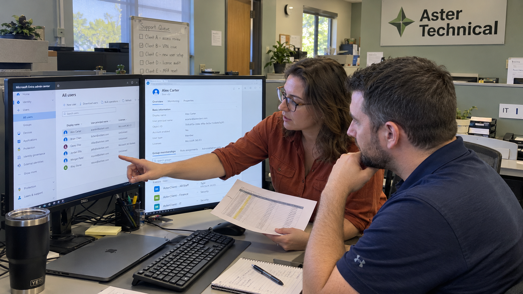 MSP lead and co-managed IT colleague review GDAP-related account access and a permissions worksheet