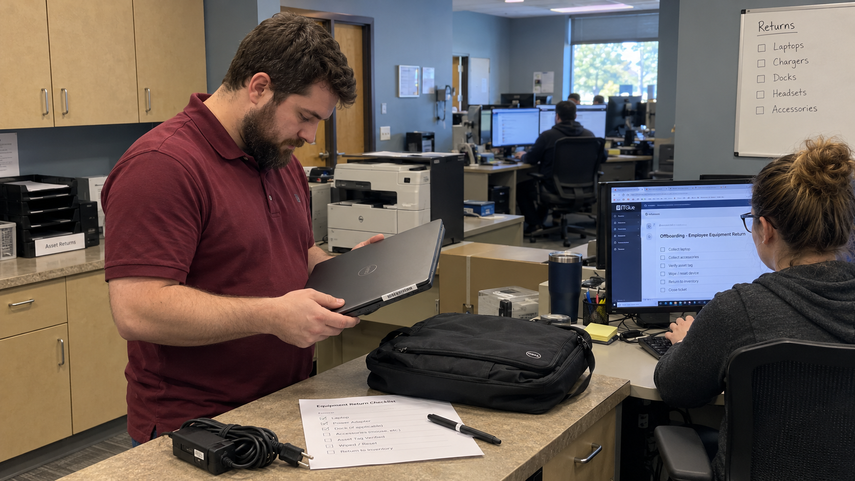 MSP staff check a returned laptop and record the asset return on an IT offboarding checklist