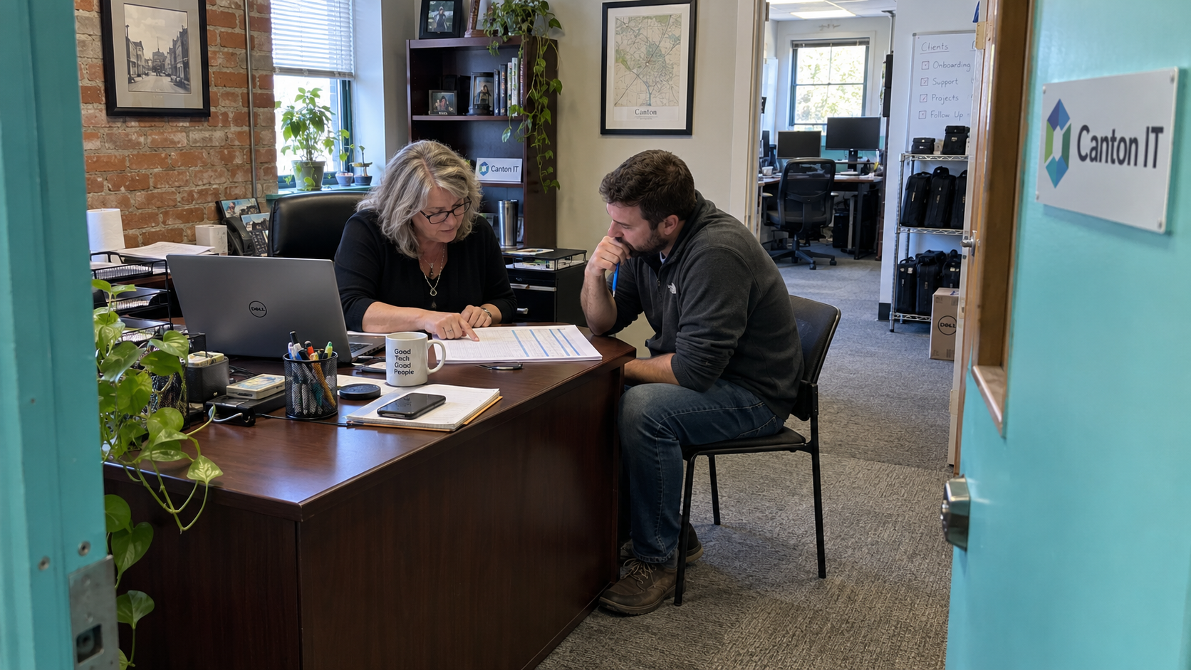 An MSP owner weighing selling a business to an employee reviews a cash-flow worksheet with her senior colleague.