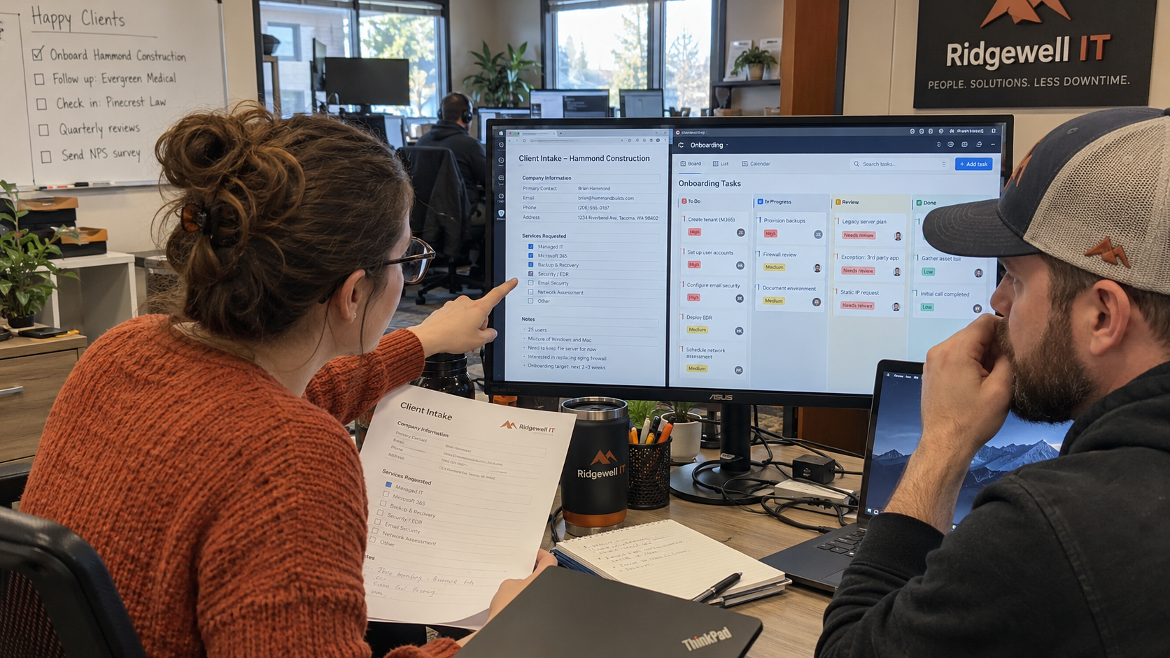 Coordinator and technician compare client intake with an onboarding task board at an MSP workstation.