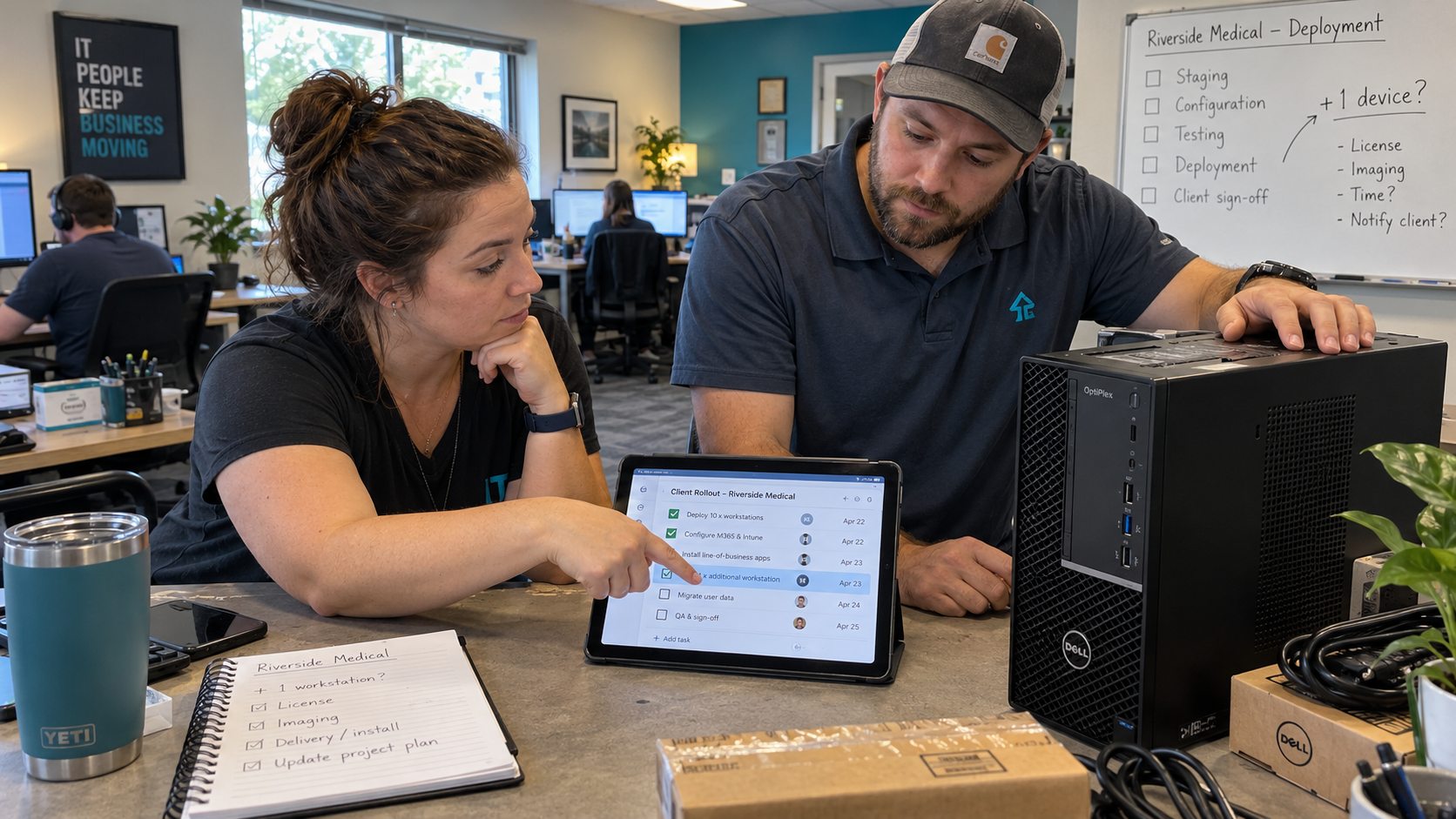 Project coordinator and technician review an extra workstation to address scope creep in IT projects