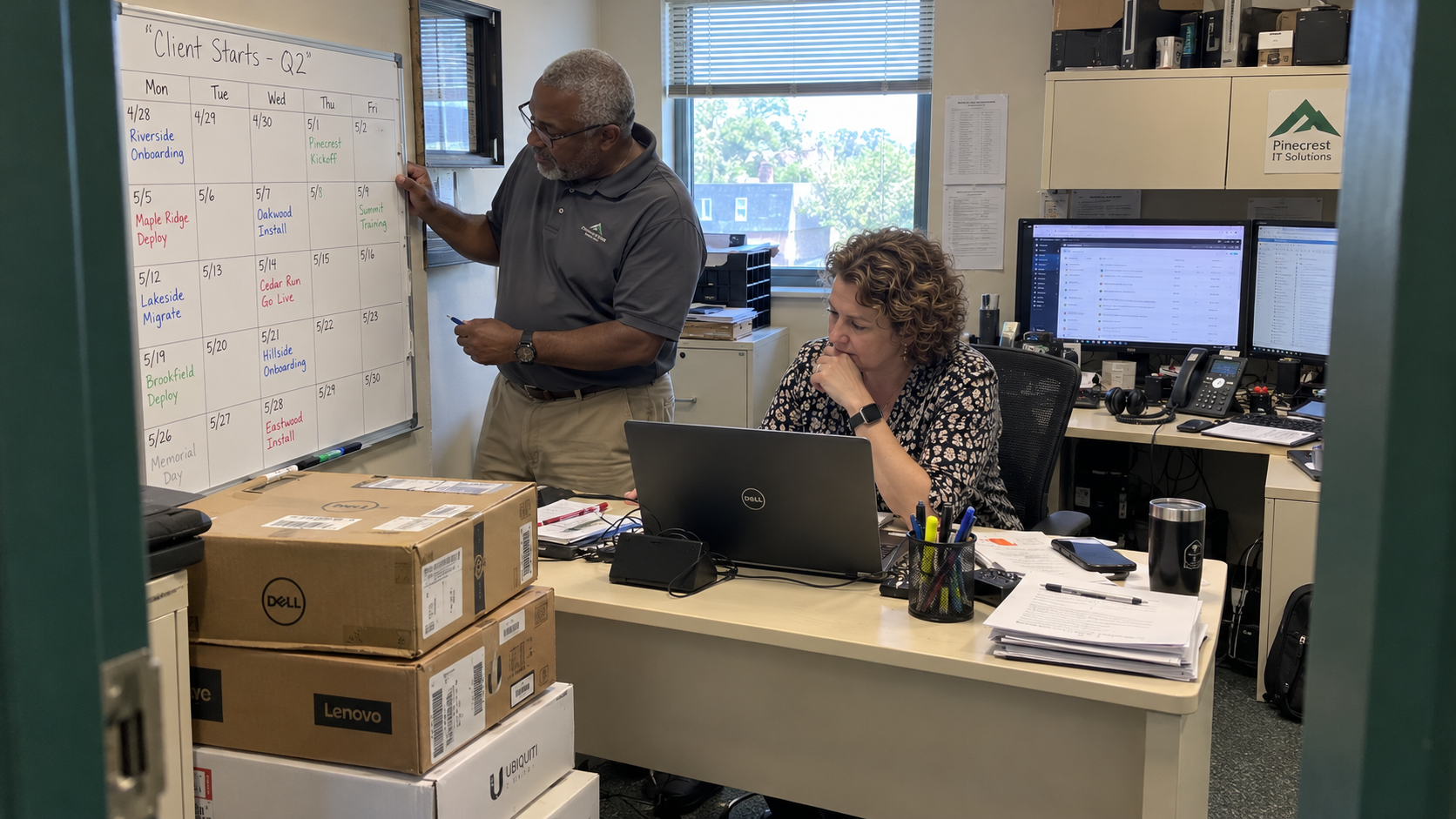 Owner and operations lead check MSP growth goals against a client-start calendar and delivery planning laptop