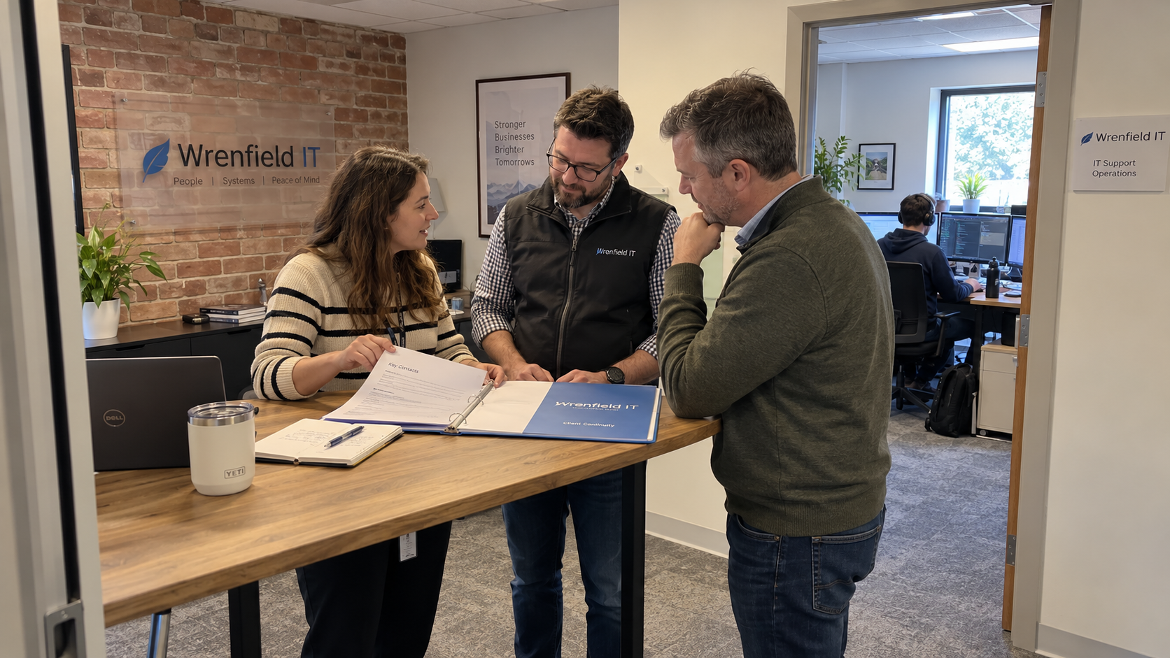 MSP colleagues and a client review a continuity packet with named cover contacts to address key person risk