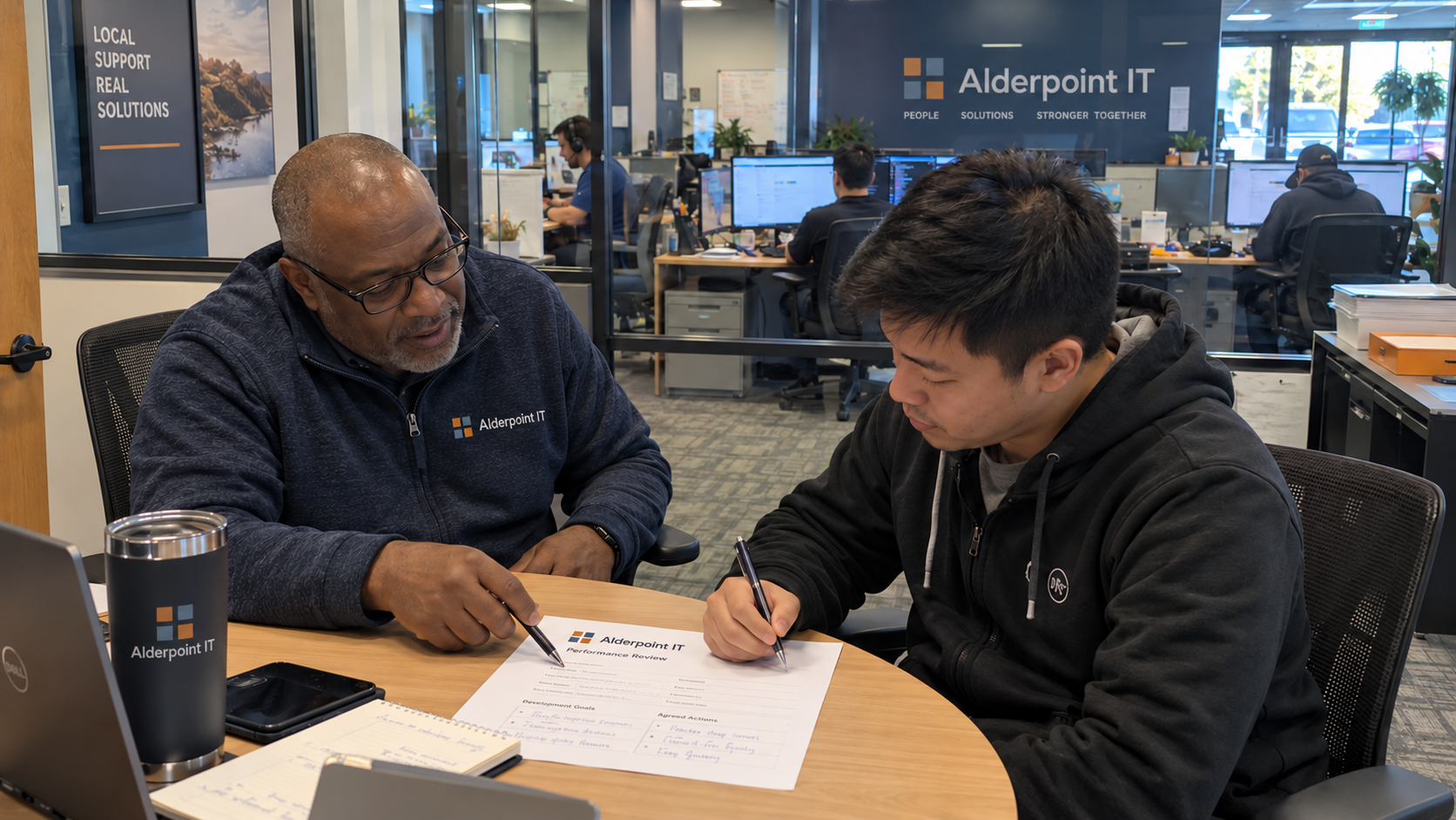 MSP manager and technician write agreed development actions on a one page performance review