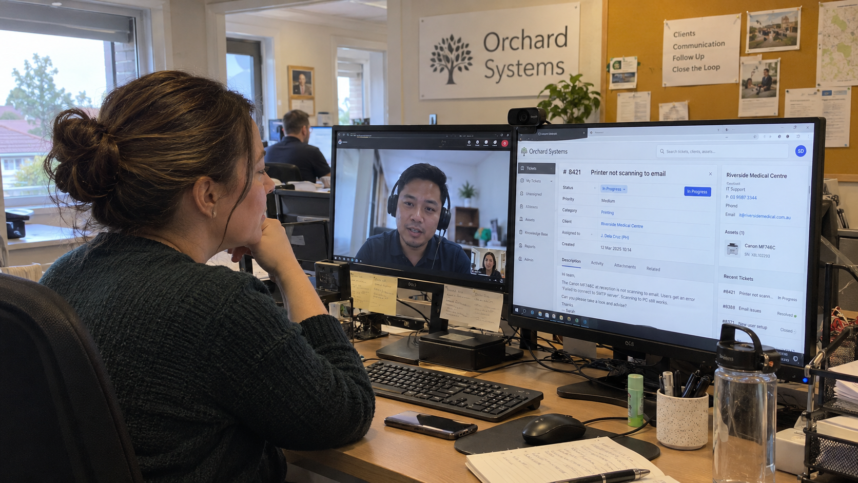 MSP lead managing offshore teams reviews a ticket handover with a Philippines technician on a video call