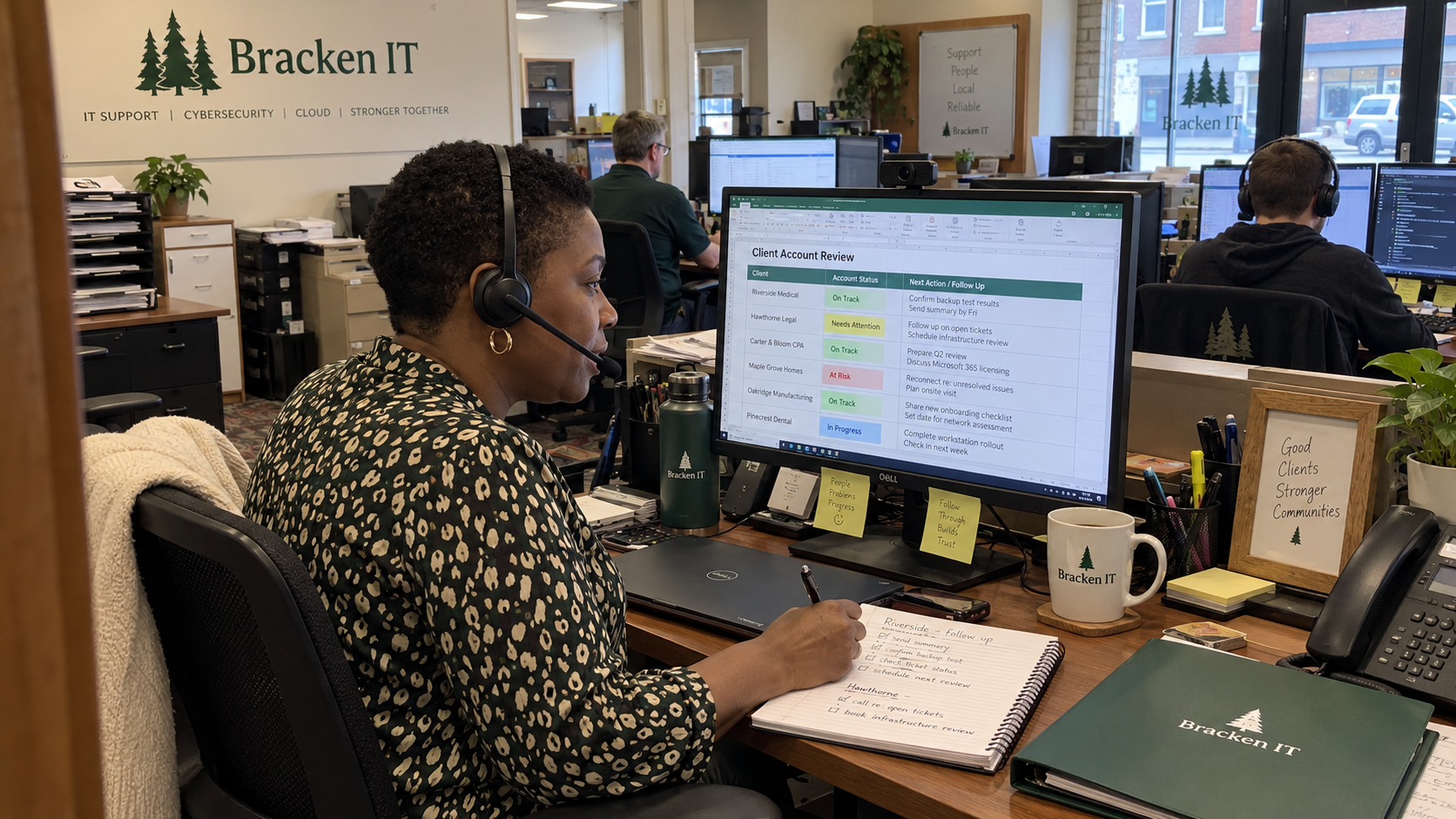 Account manager reviews a customer health score spreadsheet during a client call at an MSP workstation.