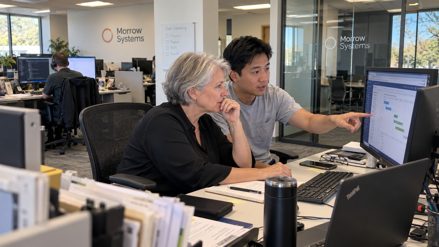 MSP account adviser and technical colleague prepare a client plan for a technology business review